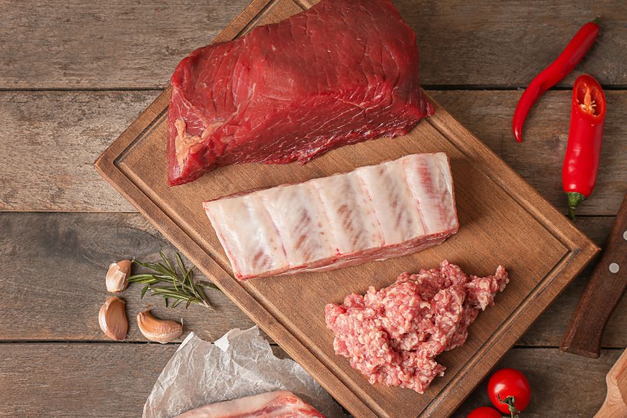 different kinds of meat in a wooden tray